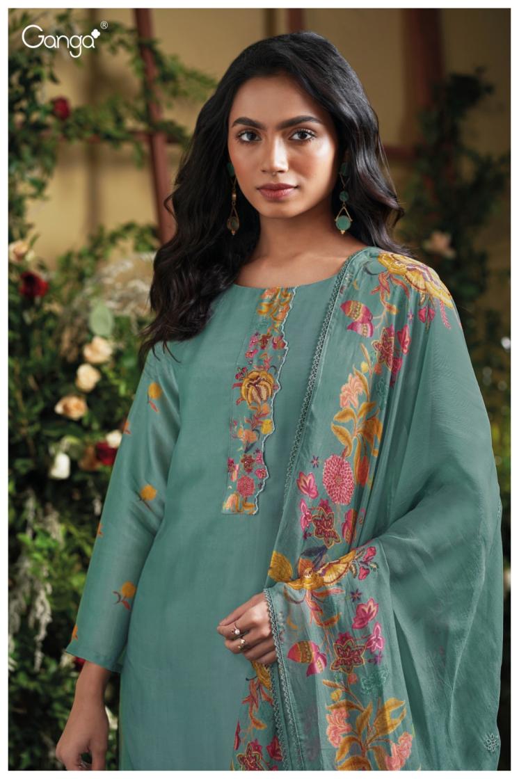 Woman wearing a green embroidered traditional outfit with a blurred floral background