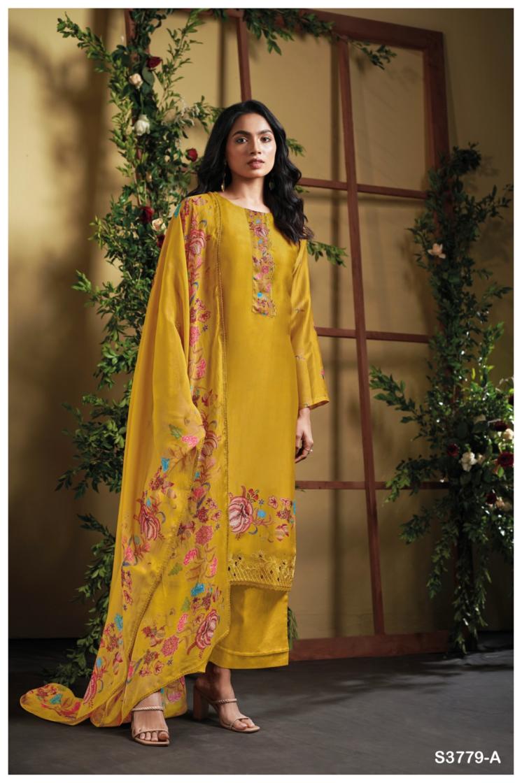Woman wearing a yellow embroidered outfit with a floral background