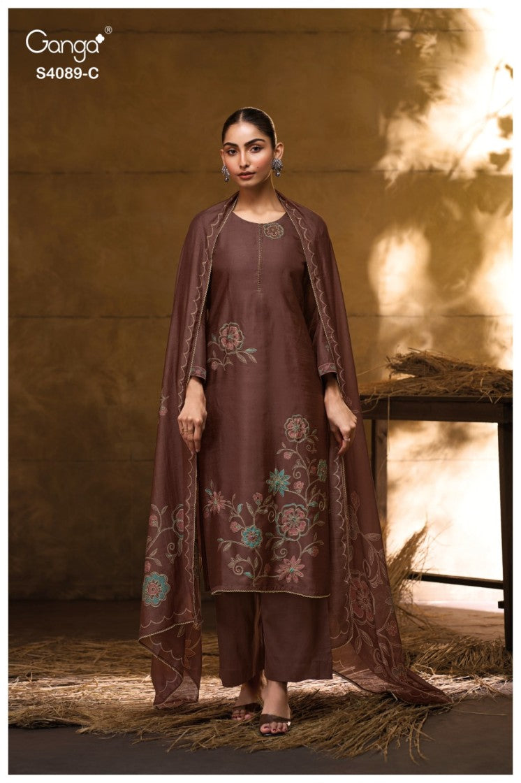 Woman wearing a brown embroidered outfit with a warm background