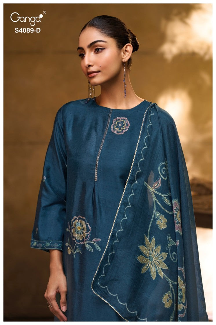Woman wearing a blue embroidered traditional outfit with a blurred background