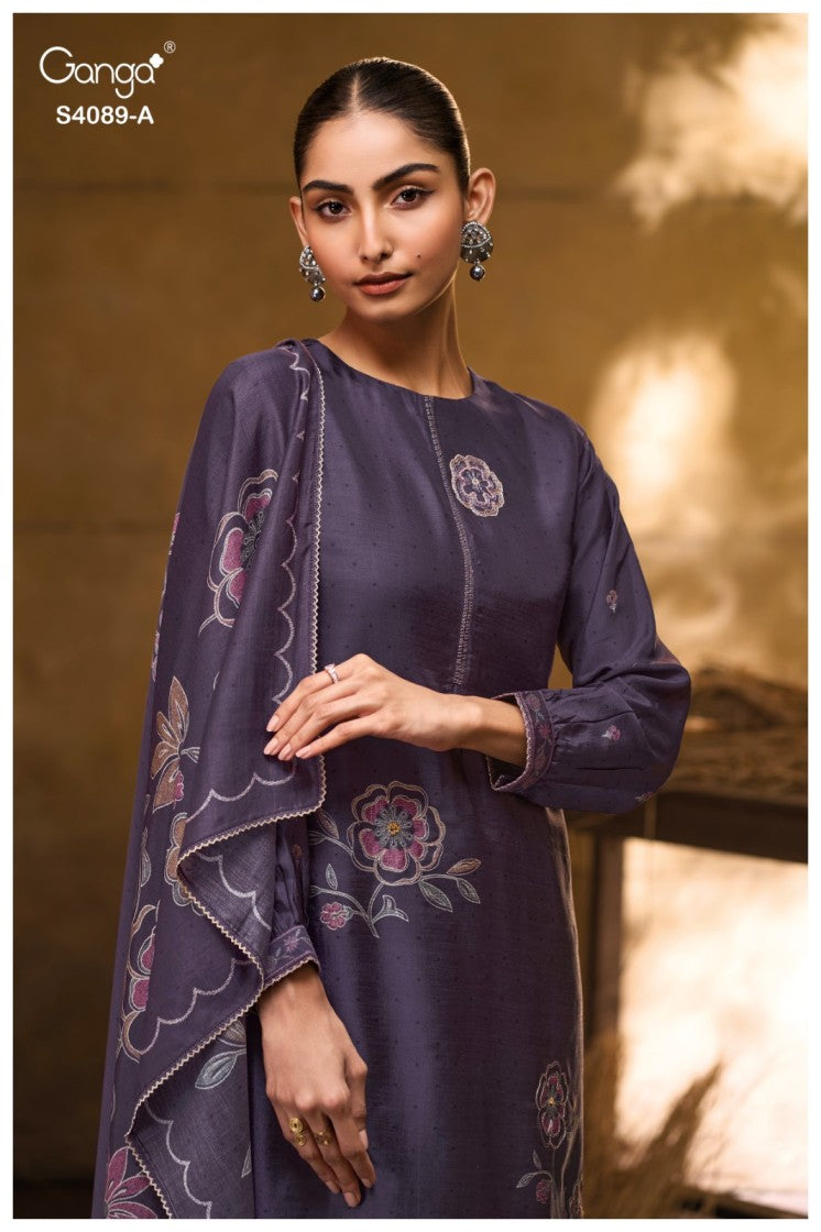 Woman wearing a dark purple embroidered outfit with a soft focus background