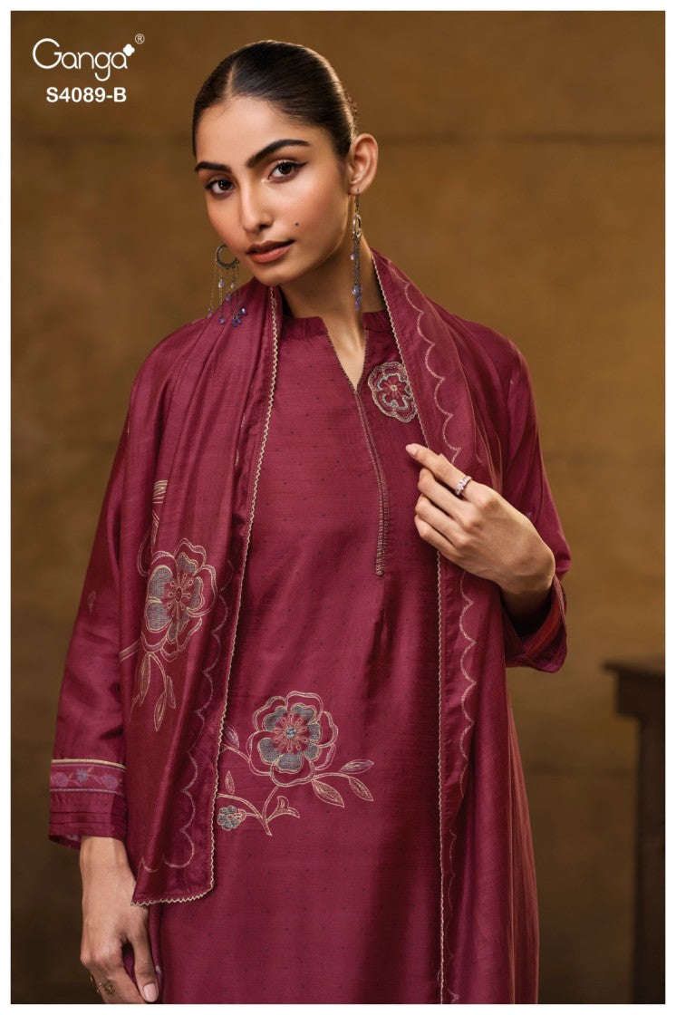 Woman wearing a maroon embroidered outfit with a brown background