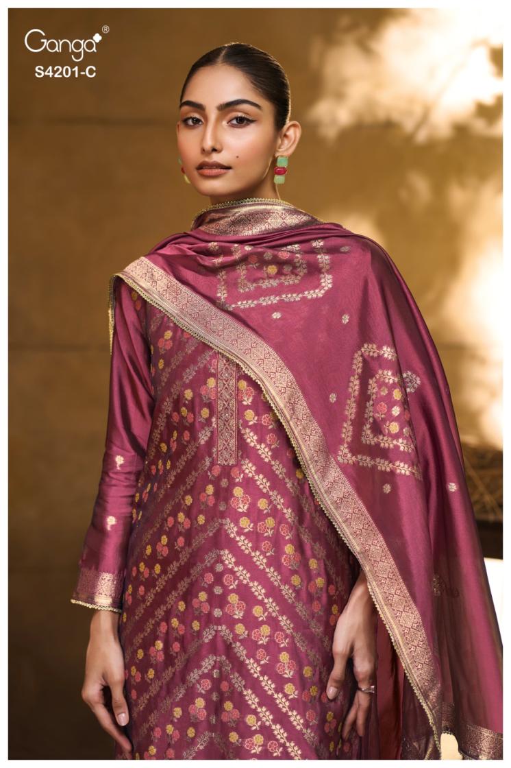Woman wearing a traditional maroon saree with gold patterns against a warm-toned background
