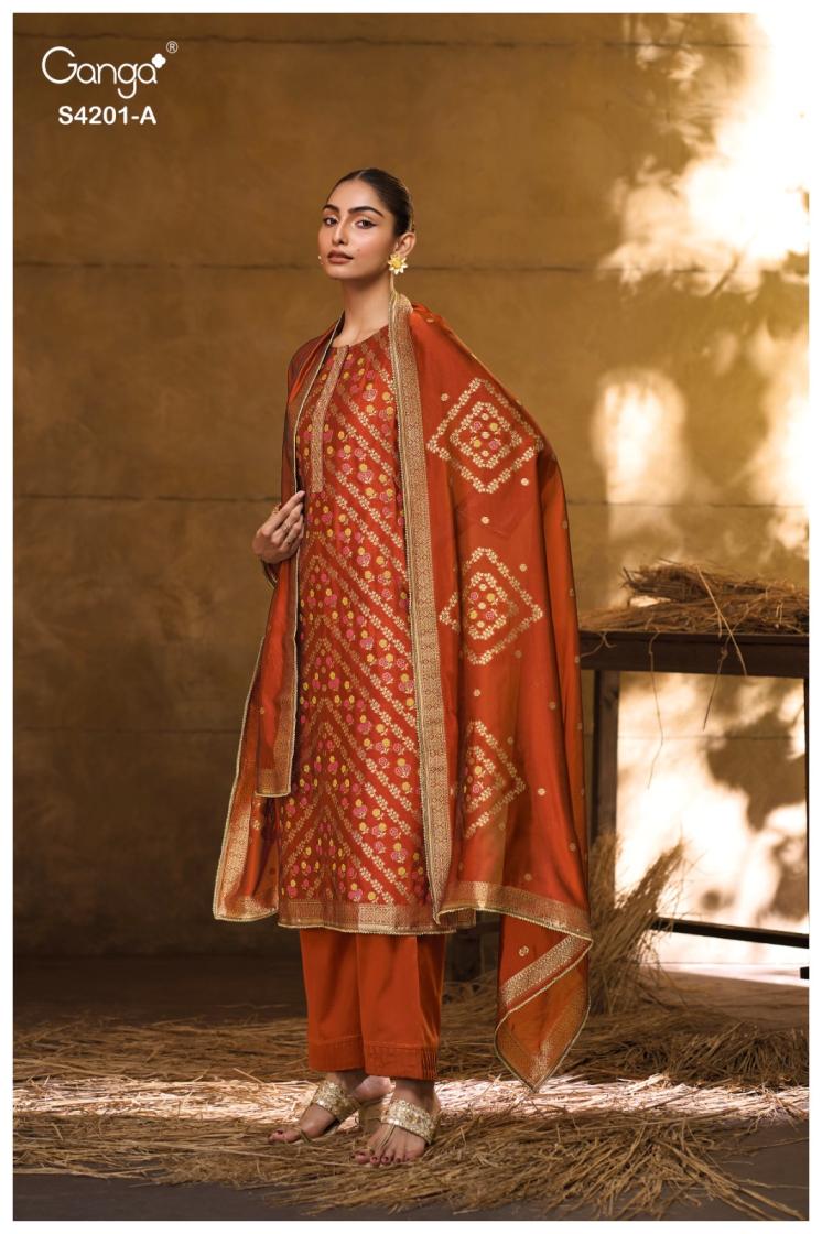 Woman wearing a traditional red and gold outfit with a matching dupatta, standing against a warm-toned background.
