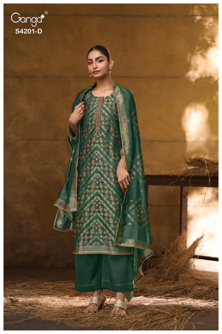 Woman wearing a green traditional outfit with a patterned dupatta against a warm-toned background.