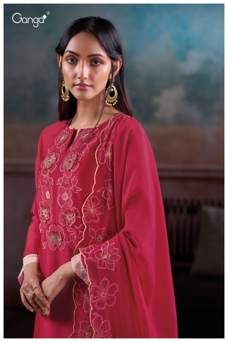 Woman wearing a pink embroidered traditional outfit with a blurred background