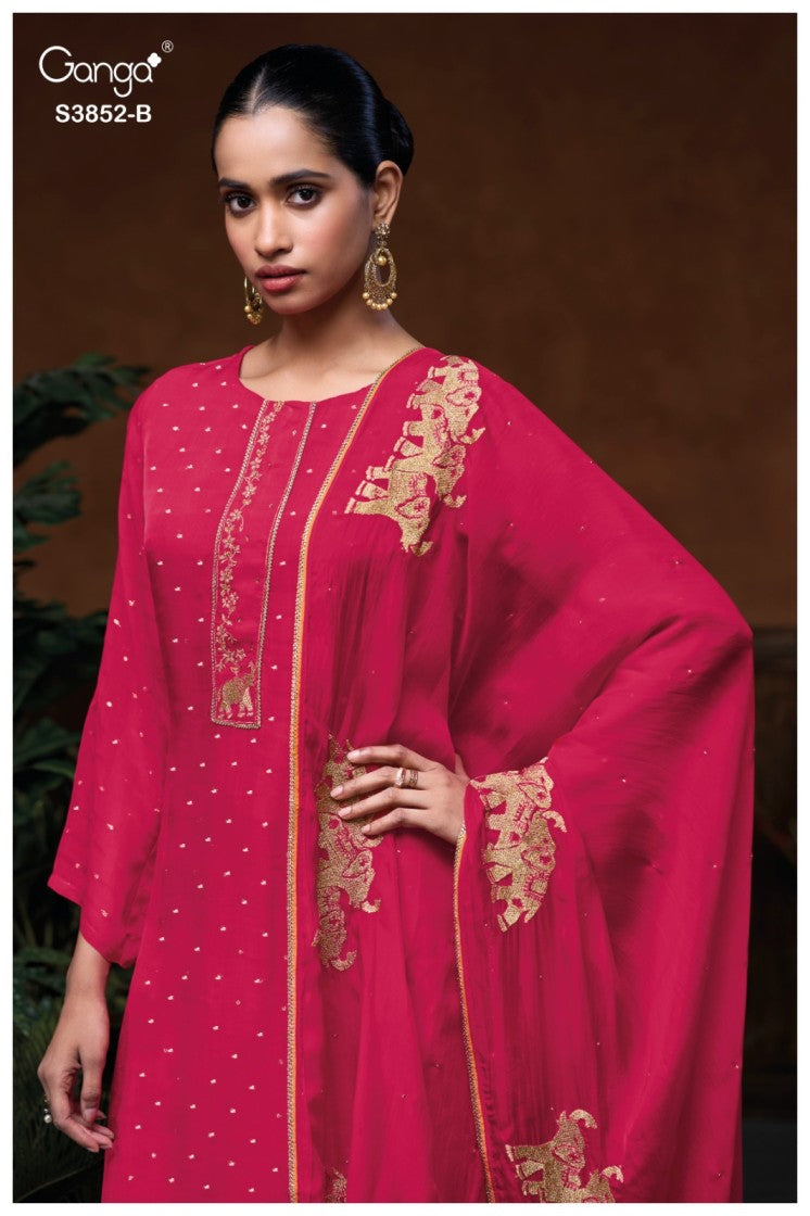Woman wearing a pink embroidered traditional outfit with a brown background