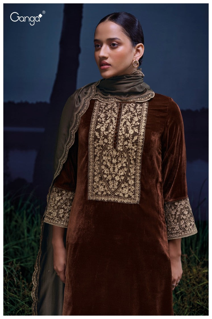 Woman wearing a brown velvet outfit with intricate embroidery against a dark background