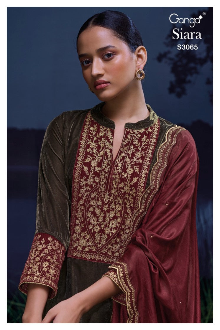 Woman wearing a maroon and brown embroidered traditional outfit with 'Ganga Siara' branding.