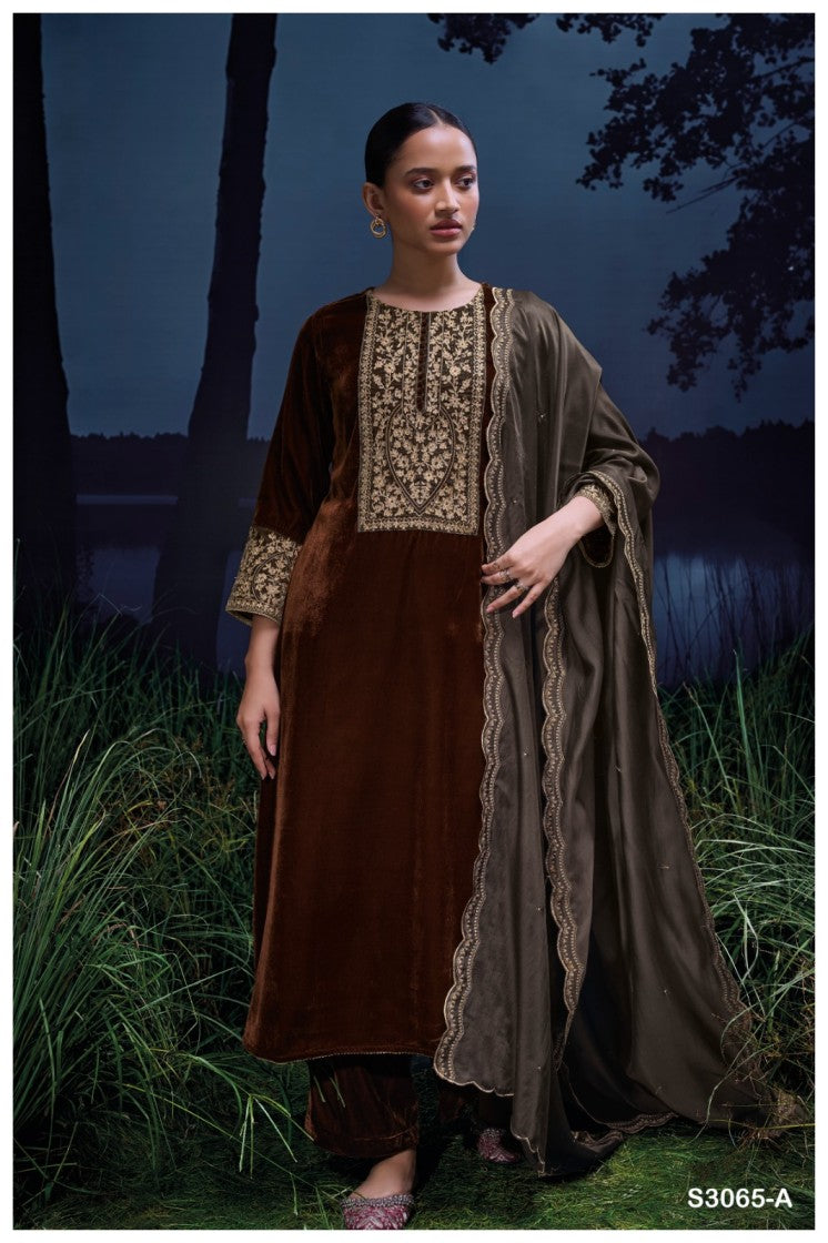 Woman wearing a traditional outfit with intricate designs in a natural setting